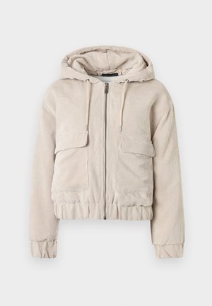 Κοντό μπεζ σακάκι από κοτλέ με κουκούλα, φερμουάρ μπροστά και δύο μπροστινές τσέπες· υφή υφάσματος και ελαστικές μανσέτες και τελείωμα.