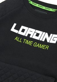 Felpa nera con la scritta "LOADING" in bianco e "ALL TIME GAMER" in verde neon, con un pannello inferiore trapuntato e collo a coste.