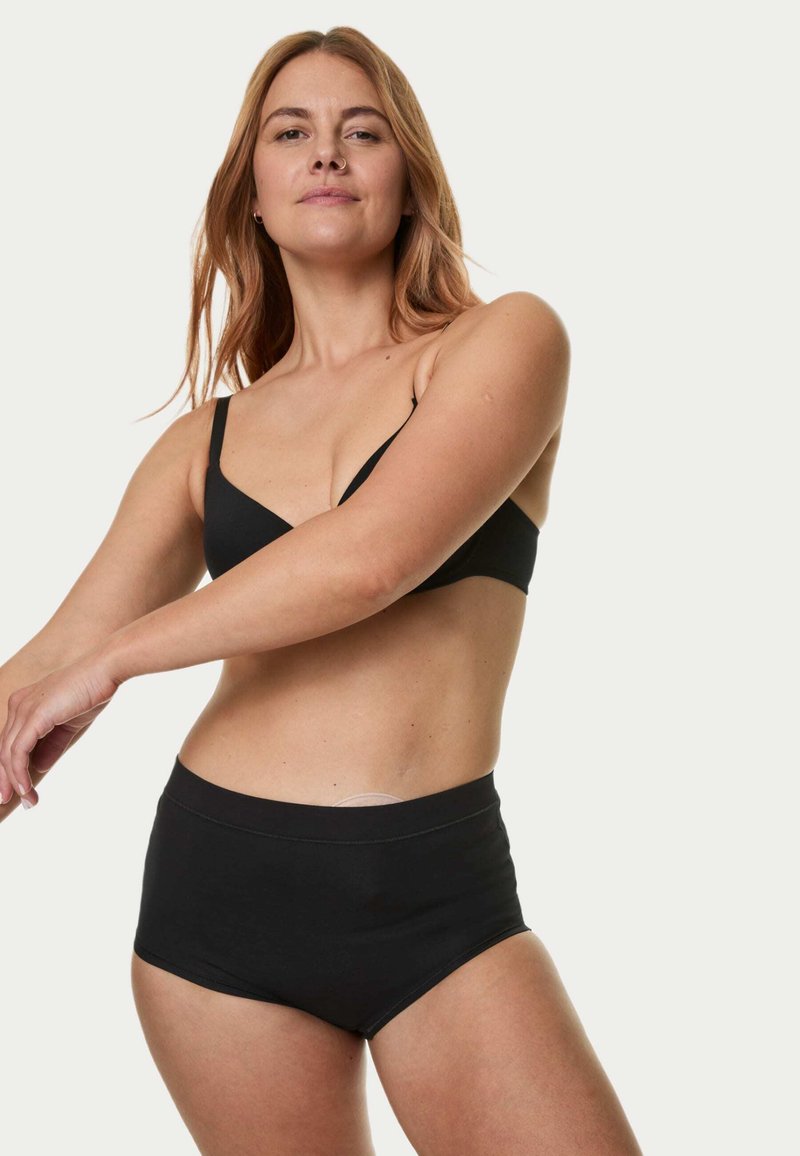 Svart bralette och högmidjade trosor i ett mjukt, elastiskt tyg. Braletten har tunna band; trosorna har en slät midjeresår.