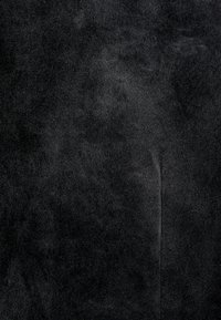 Black suede fabric with a soft, textured surface. Features slight sheen and an even color throughout. Smooth with no visible patterns or accents.