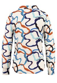 Pitkähihaista paitaa, jossa on kauluksellinen kaula-aukko. Sisältää monivärisen abstraktin kuvion kermaisella taustalla. Pehmeä kangas ja joustavat hihat.