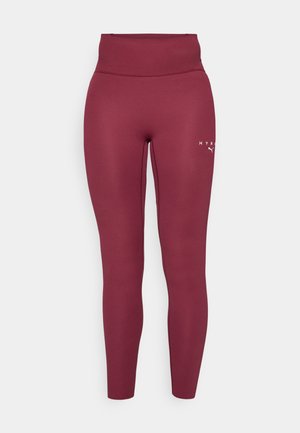 Leggings bordeaux fabriqués à partir d'un tissu extensible, avec une taille haute, une coupe ajustée, présentant un petit logo imprimé sur la cuisse gauche.