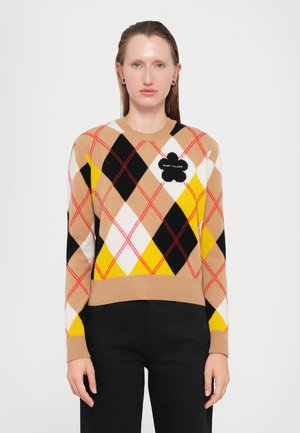 Knit sweater with a tan, black, white, and yellow argyle pattern; features a black floral appliqué with "MARC JACOBS" text on the chest.
