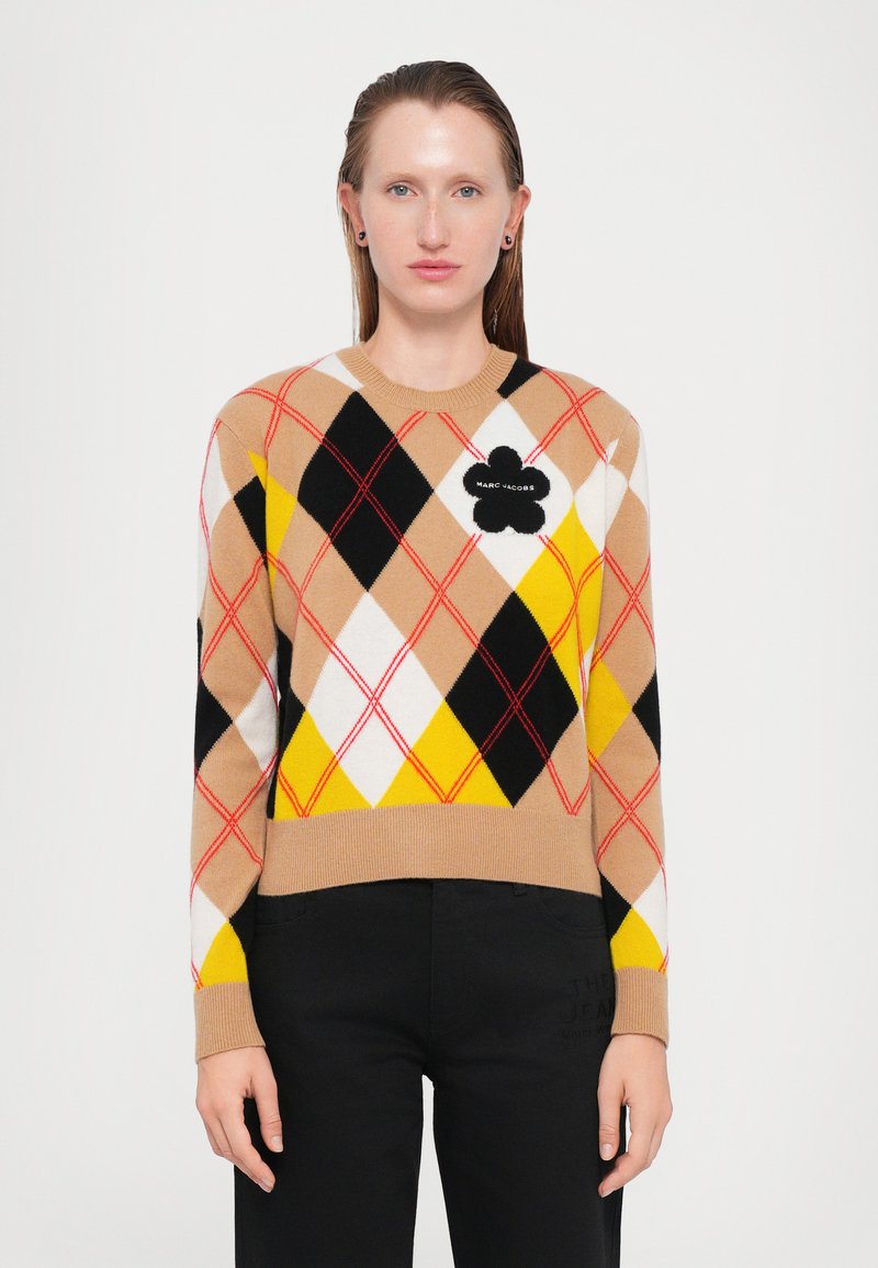 Knit sweater with a tan, black, white, and yellow argyle pattern; features a black floral appliqué with "MARC JACOBS" text on the chest.