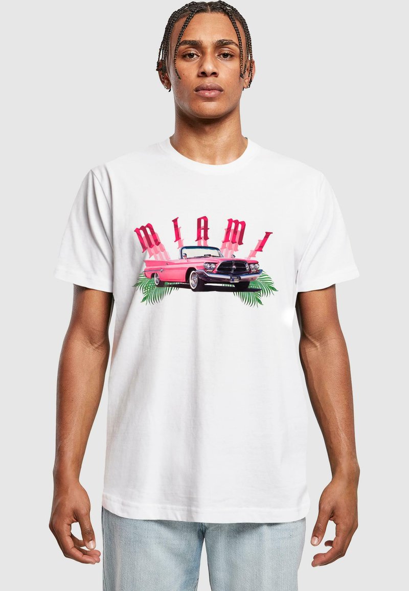 White cotton t-shirt featuring a colorful "MIAMI" graphic, a pink convertible car, and palm leaves, with a relaxed fit and crew neck design.