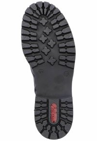 Black rubber boot sole with deep treads, featuring a red logo stamped in the center, size 37 marked on the side, textured for grip.