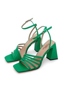 Sandalias de tacón alto verdes con tiras, punta cuadrada, correas texturizadas y tacón robusto. Incluye una correa ajustable en el tobillo y un acabado suave.