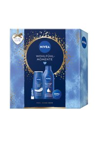 NIVEA gift set in a blue box with gold accents. Contains three products: a cream, body milk, and lip balm, featuring white branding details.