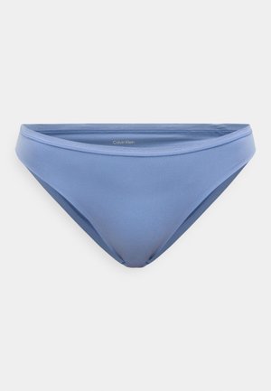 Hele sinine bikiinialuspüks, millel on sile tekstuur, madal vöökoht ja peen bränding vöökohal. Ilma nähtavate kinnituste või mustriteta.