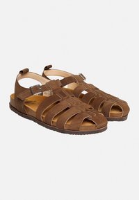Braune Wildledersandalen mit offenem Zeh, Überkreuzriemen-Design, verstellbare Schnalle und strukturiertes Fußbett. Flacher Absatz für Komfort.