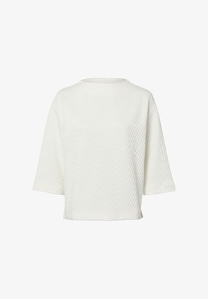 Top bianco testurizzato con motivo a diamante, scollo a barca e maniche corte. Vestibilità casual con fodera interna liscia.