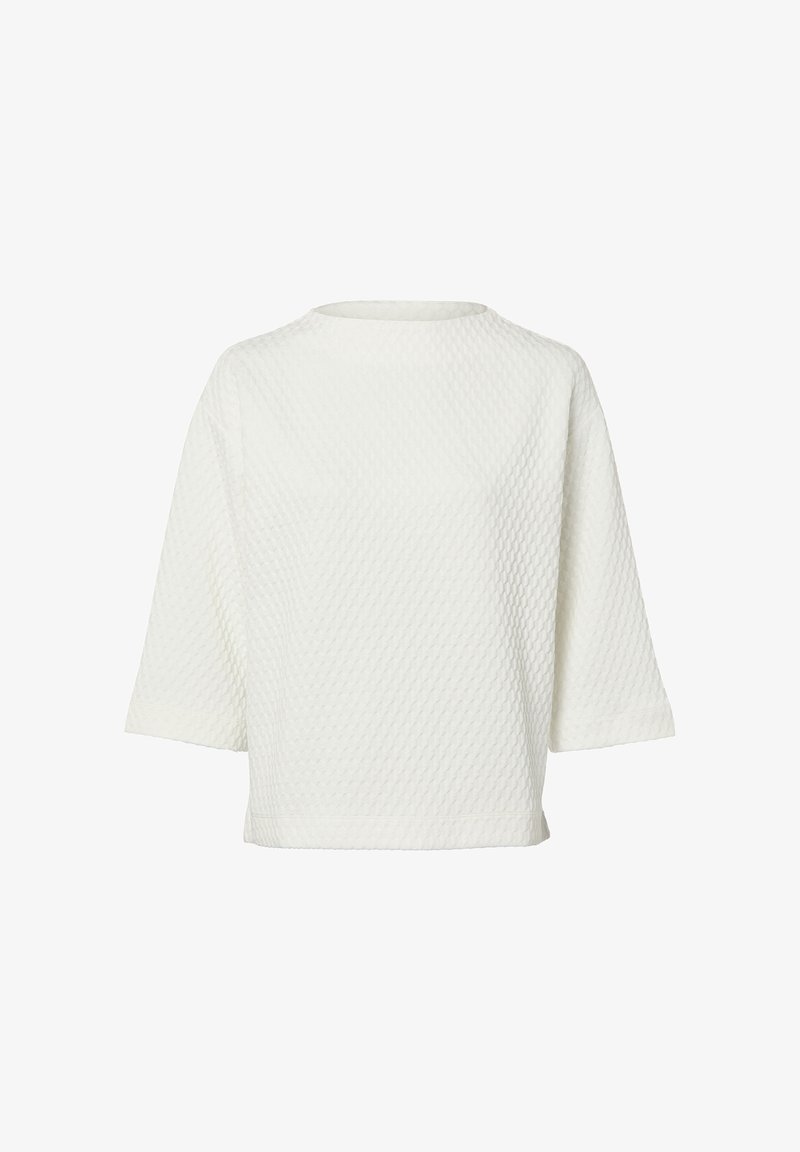 Balts rakstains tops ar dimanta rakstu, laivas formas izgriezumu un īsām piedurknēm. Ikdienas piegriezums ar gludu iekšējo oderējumu.