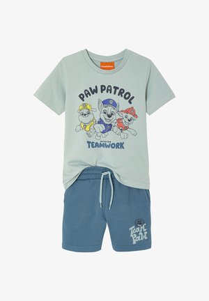 Light green Paw Patrol t-shirt with three pups and "Mission Teamwork" text, paired with blue drawstring shorts with "Team Paw" logo.