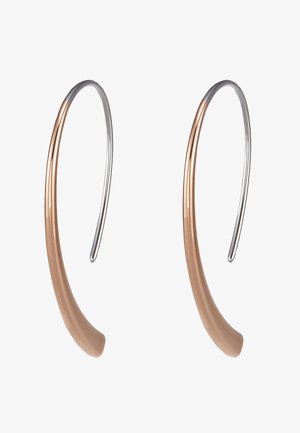 Pendientes de aro de metal con forma curva, con un acabado en bronce y plata, que exhiben una textura suave y un diseño minimalista.