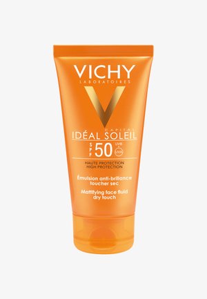 VICHY Ideal Soleil sun protection cream in a bright orange tube, labeled SPF 50, features a matte texture and a flip-top cap design.