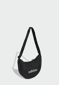 Black, semi-circular bag with adjustable strap, featuring a gathered top and a visible Adidas logo in white. Made of durable fabric.