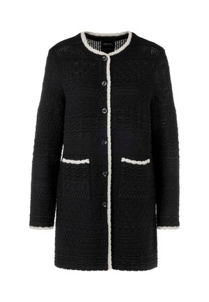 Black knitted cardigan featuring textured patterns, white trim, button closure, and two front pockets. Long sleeves.