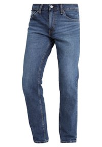Vaqueros de mezclilla azul con un diseño de pierna recta, que cuentan con bolsillos delanteros, cremallera y costuras en contraste. Ropa casual clásica.