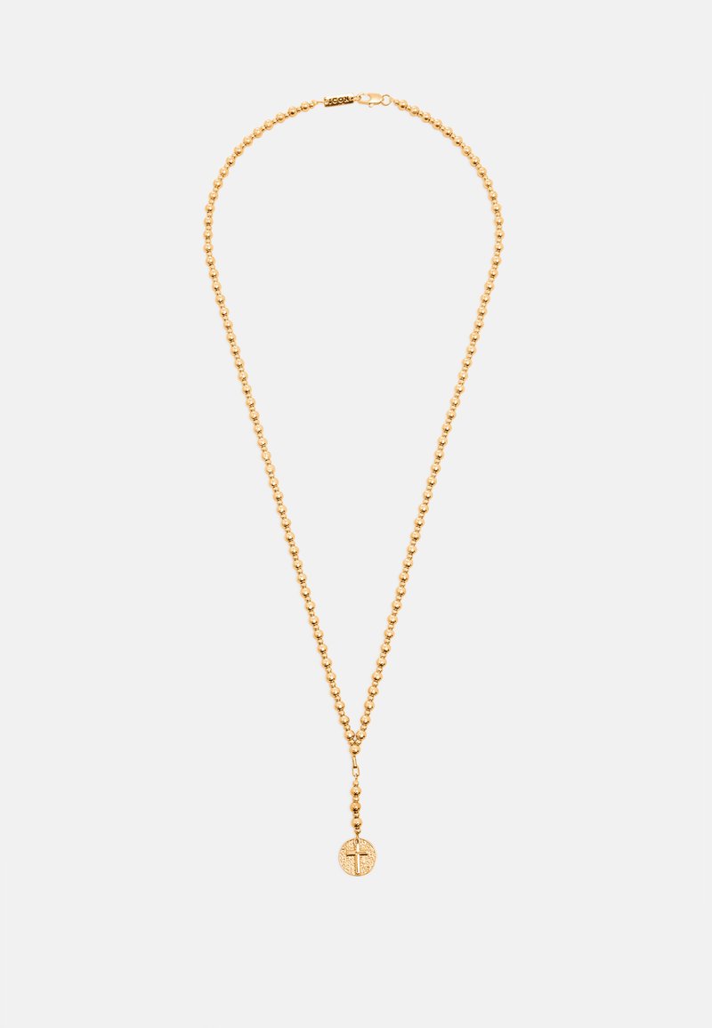 Collar de rosario con cuentas doradas y un colgante redondo con una cruz grabada, mostrado sobre un fondo liso y claro.