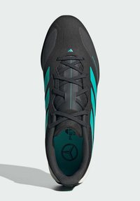 Black sports shoe with teal accents, featuring a sleek design, textured surface, and lace-up closure. Logo displayed on the insole.