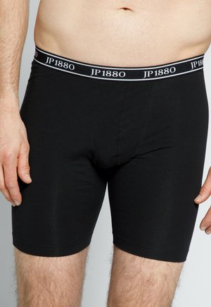 Schwarze Boxershorts aus glattem Stoff mit körpernahem Schnitt. Sie verfügen über einen breiten Elastikbund mit "JP1880" in weißer Schrift.