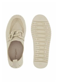 Beige instap-schoen met geperforeerd ontwerp, opvallend kettinkje aan de voorkant, textuurzool en logo nabij de hiel.