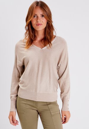 Beige pullover sweater met V-hals, lange mouwen en een geribbelde onderrand. Gelaagd, licht glanzend stof met knoopdetails op de manchetten.