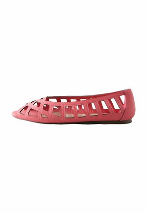Red flat sandal with open lattice design, rounded toe, and low heel, shown in side profile on white background.