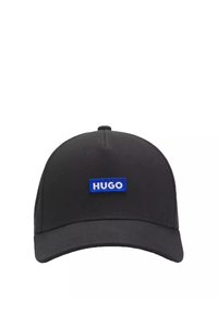 Schwarze Baseballkappe mit runder Krone und flachem Schirm. Auf der Vorderseite befindet sich ein blauer rechteckiger "HUGO"-Aufnäher.