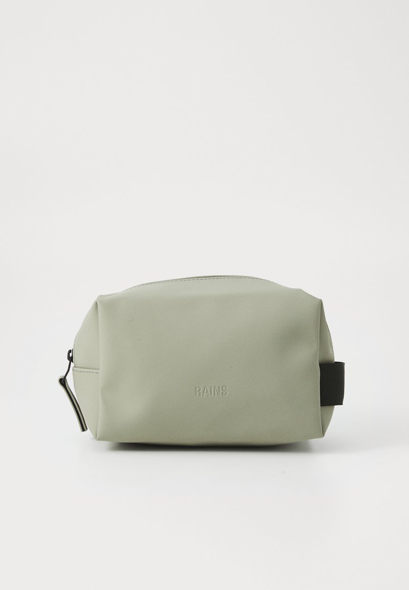 Green waterproof cosmetic bag with a smooth texture, rounded shape, black accent strap, and embossed "RAINS" logo on the front.