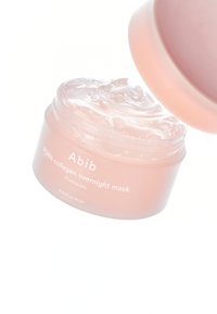 Maschera notturna al collagene PDRN in un barattolo trasparente e rotondo con un coperchio rosa tenue; contiene una consistenza trasparente simile a gelatina. Capacità di 80 mL.