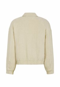 Cream-colored cropped jacket with a textured fabric, featuring a collar and elasticated hem. Long sleeves with fitted cuffs.