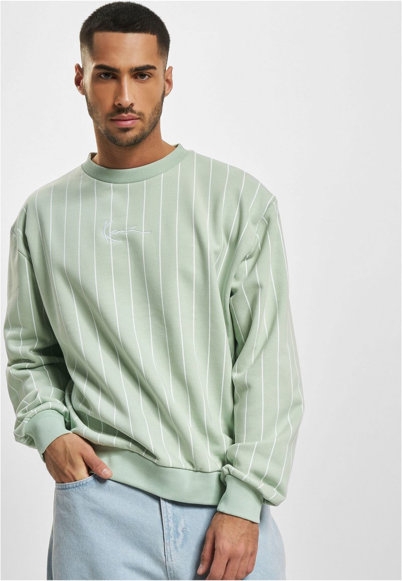 Mint green pullover sweatshirt with vertical white stripes, ribbed cuffs, and hem. Features a small embroidered logo on the chest.