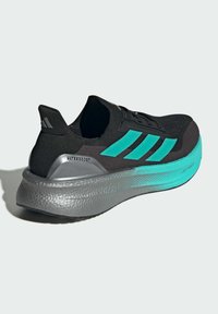 Black athletic shoe with a textured black upper, turquoise stripes, and a thick gray midsole featuring "UltraBoost" detail.