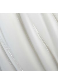Glossy white material with smooth, wavy texture and visible light reflections. Features undulating lines creating a flowing appearance.