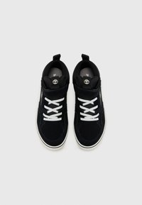 Black suede high-top sneakers with white laces, featuring a padded collar and logo on the tongue. Rubber sole and textured design elements.