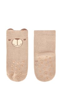 Helle beigefarbene Socken mit einem Bärenkopfdesign, braunen Akzenten an den Bündchen und strukturierten Pfotenabdrücken an der Sohle für besseren Halt.
