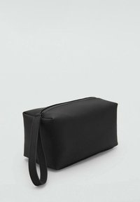 Black cosmetic bag with a rectangular shape, made of smooth material, featuring a top zipper and a side handle for easy carrying.