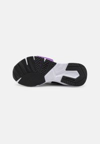 Semelle de chaussure de sport présentant une base en caoutchouc noir avec des motifs de crampons en zigzag et circulaires, renforcée par des accents blancs et violets.