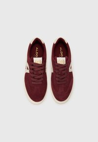 Sneaker sportive color bordeaux realizzate in mesh e suede. Dettagli crema sui lati e sulla linguetta, con lacci marroni e logo.