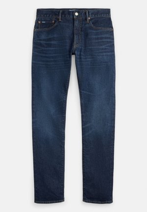 Tmavomodré slim-fit rifle s jemným vyblednutím na stehnách, dizajn s piatimi vreckami a zapínaním na gombík v páse.