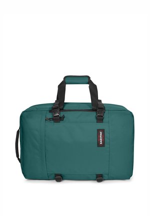 Sac de voyage rectangulaire vert avec poignées noires, poche avant zippée, poignée latérale et étiquette de marque Eastpak sur le devant.