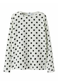 Langermige shirt in het wit met zwarte stippen. Ronde hals, gestructureerde stof en zijsplitten voor gemak in beweging.