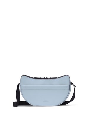 Light blue crescent-shaped crossbody bag with black adjustable strap and top zipper closure on a white background.