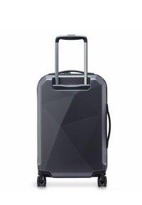 Hard-shell suitcase in dark gray with a geometric pattern, featuring a telescopic handle and four wheels for mobility.