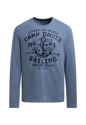 Long-sleeve blue T-shirt made of cotton, featuring a nautical-themed print with text and an anchor design in contrasting dark colors.