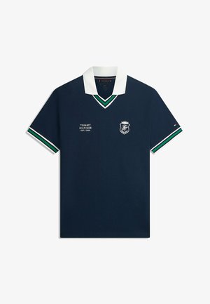 Granatowa koszulka polo z białym kołnierzykiem, zielono-białe paski na rękawach i kołnierzyku, logo Tommy Hilfiger i napis na piersi.