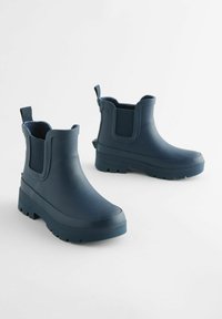 Tengerészeti vízálló bokacsizmák gumiból, texturált felülettel, elasztikus oldalsó panelek nélkül és robusztus mintázott talppal.