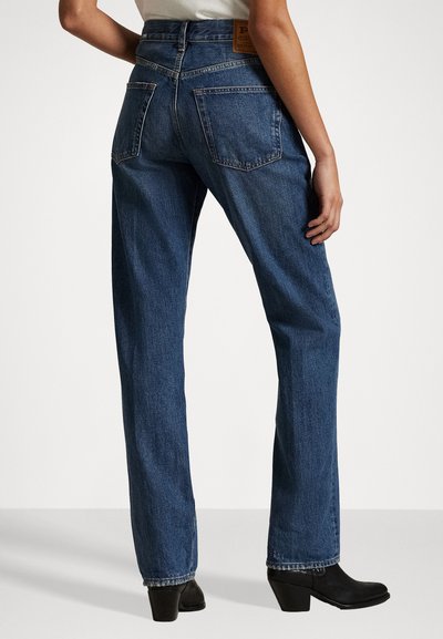 Blå denim rett ben jeans med høy livlinje, to baklommer og et skinne merke på baksiden. Glatt tekstur, uformell design.