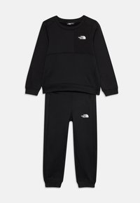 Sweatshirt noir et ensemble de pantalons de survêtement assortis en tissu doux. Présente un logo sur la poche de la poitrine et sur les hanches, avec des poignets et une taille côtelés.